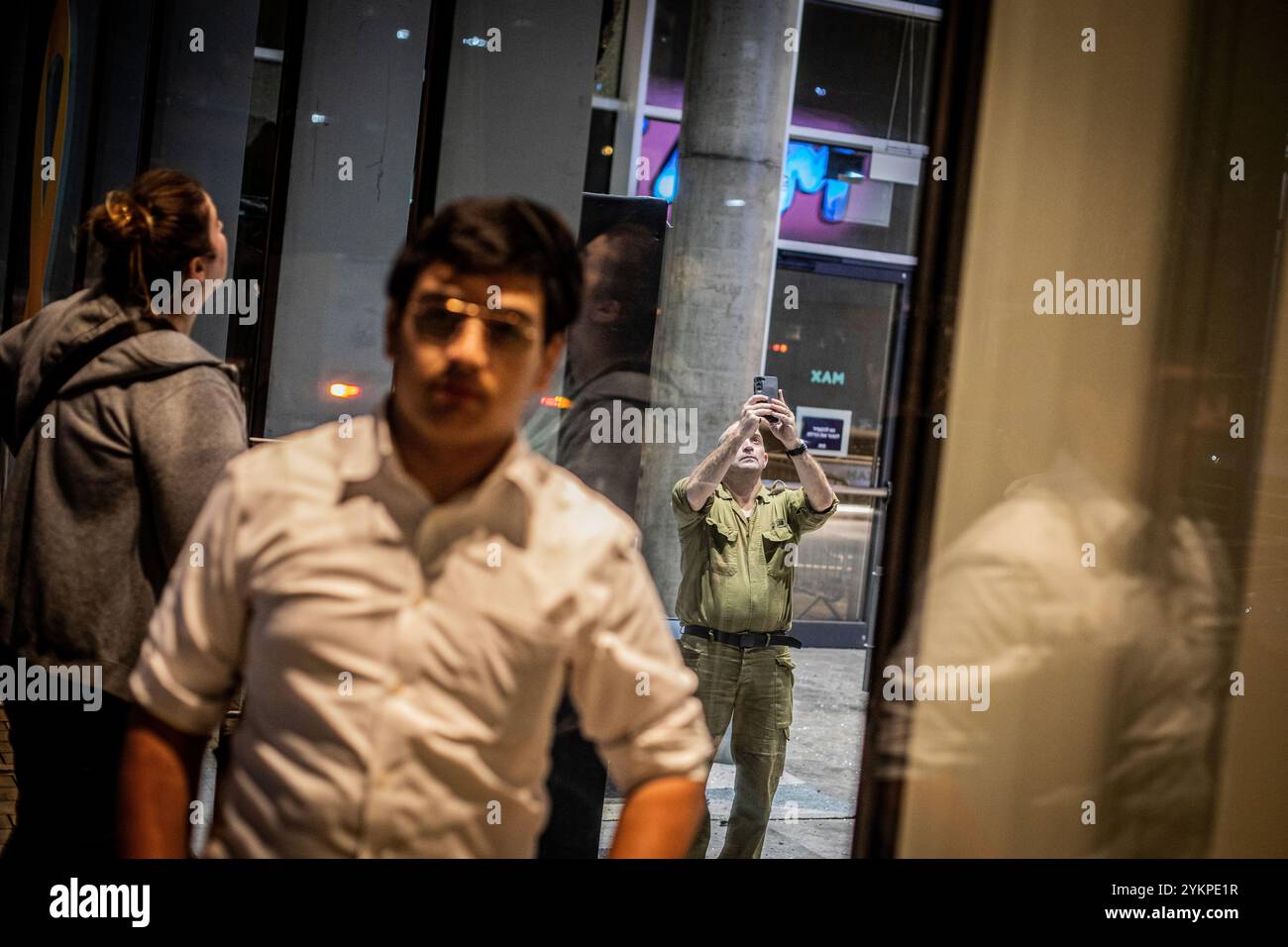 Ramat Gan, Israele. 19 novembre 2024. Un soldato israeliano fotografa i danni in un sito di impatto a Ramat Gan a est di Tel Aviv, lunedì 18 novembre 2024. Una persona è stata uccisa e diciannove feriti in diversi bombardamenti lanciati dal Libano nel nord di Israele, e nella zona di Tel Aviv lunedì. Foto di Eyal Warshavsky. (Foto di Eyal Warshavsky/SOPA Images/Sipa USA) credito: SIPA USA/Alamy Live News Foto Stock