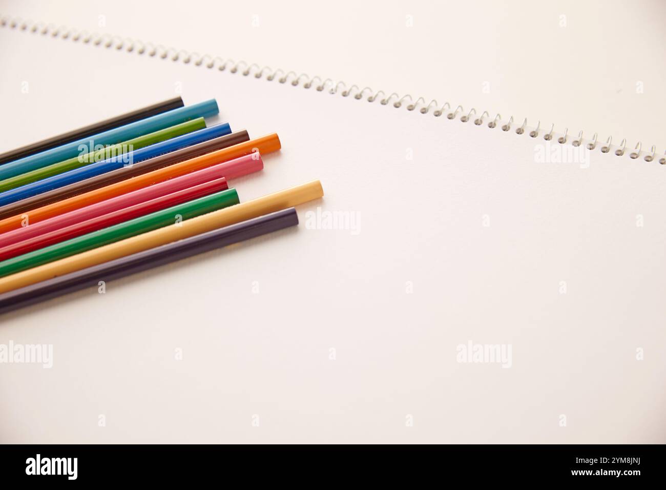 Matite colorate sul quaderno Foto Stock
