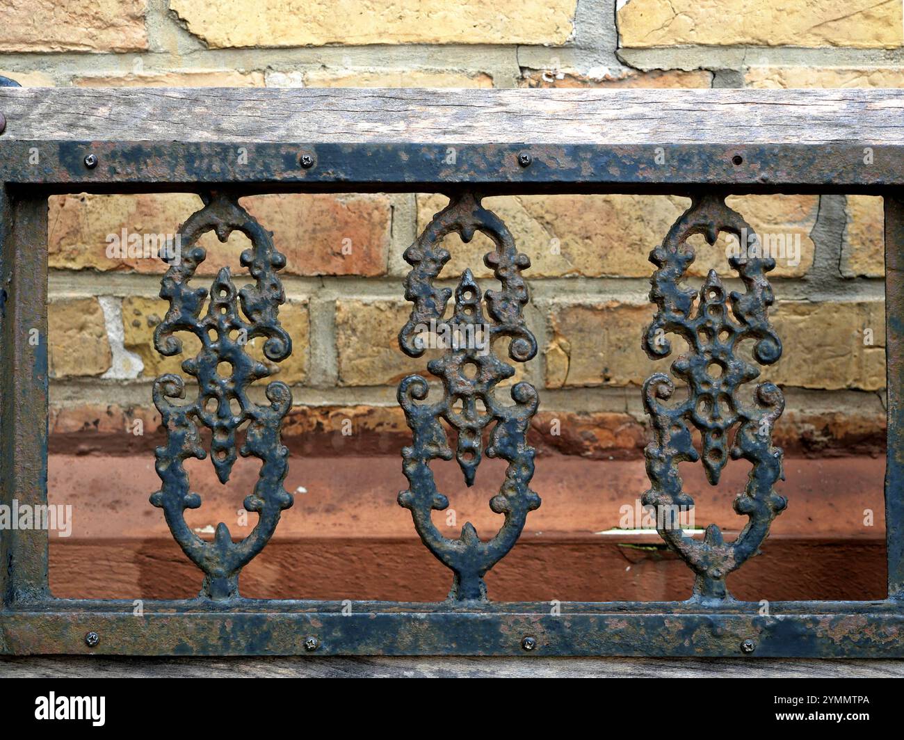 Oggetto dal design rustico: Schienale da banco in ghisa forgiato a mano. Unico e caratteristico. Foto Stock