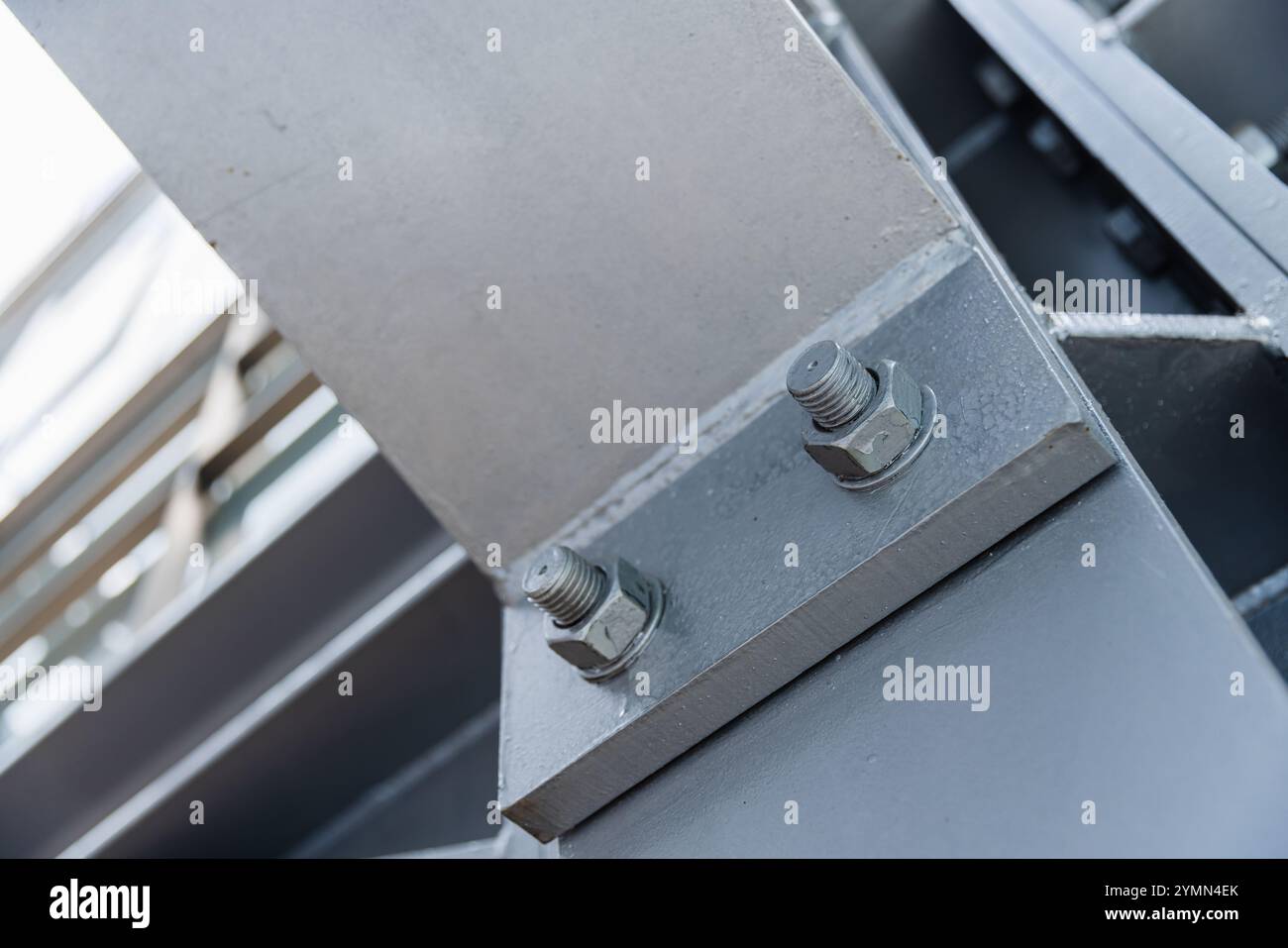 Foto di sfondo astratta dell'architettura industriale con messa a fuoco morbida selettiva. Strutture metalliche grigie collegate con bulloni, foto ravvicinata Foto Stock