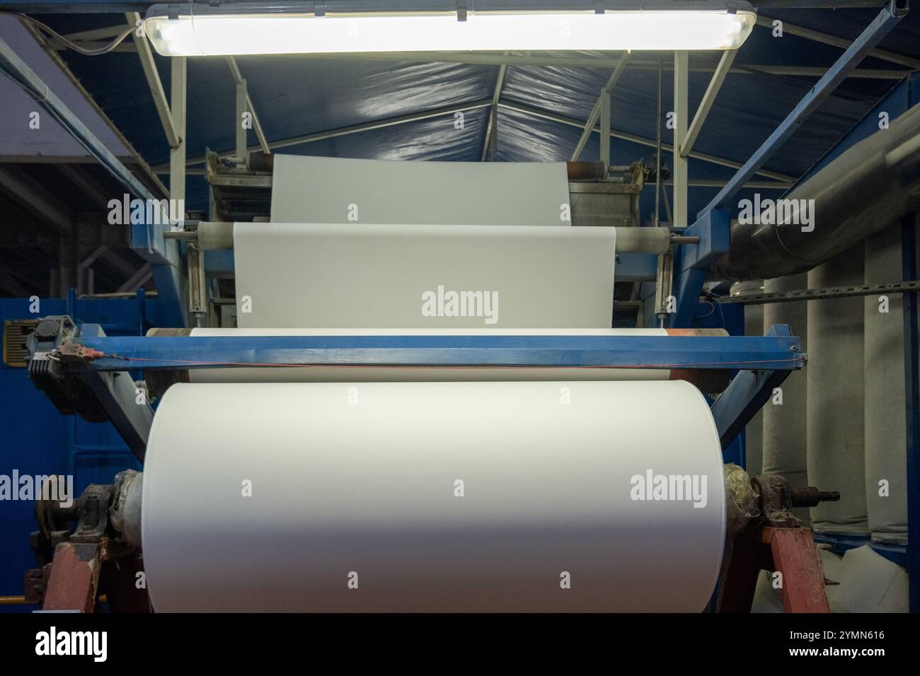 Linea di impianti industriali per macchine tessili in una fabbrica tessile. Foto Stock