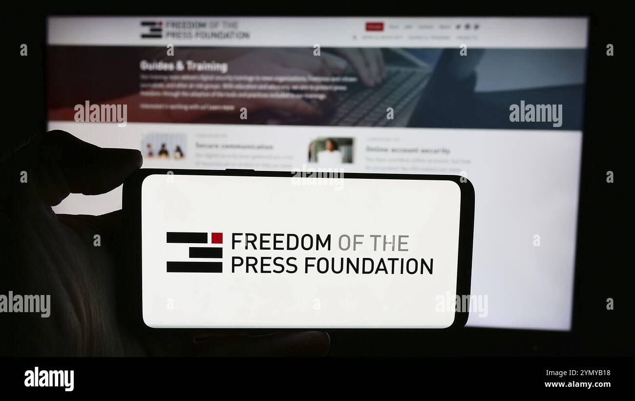 Stoccarda, Germania, 05-23-2024: Persona che tiene un cellulare con il logo dell'organizzazione Freedom of the Press Foundation (FPF) davanti alla pagina web. Concentrati su Foto Stock