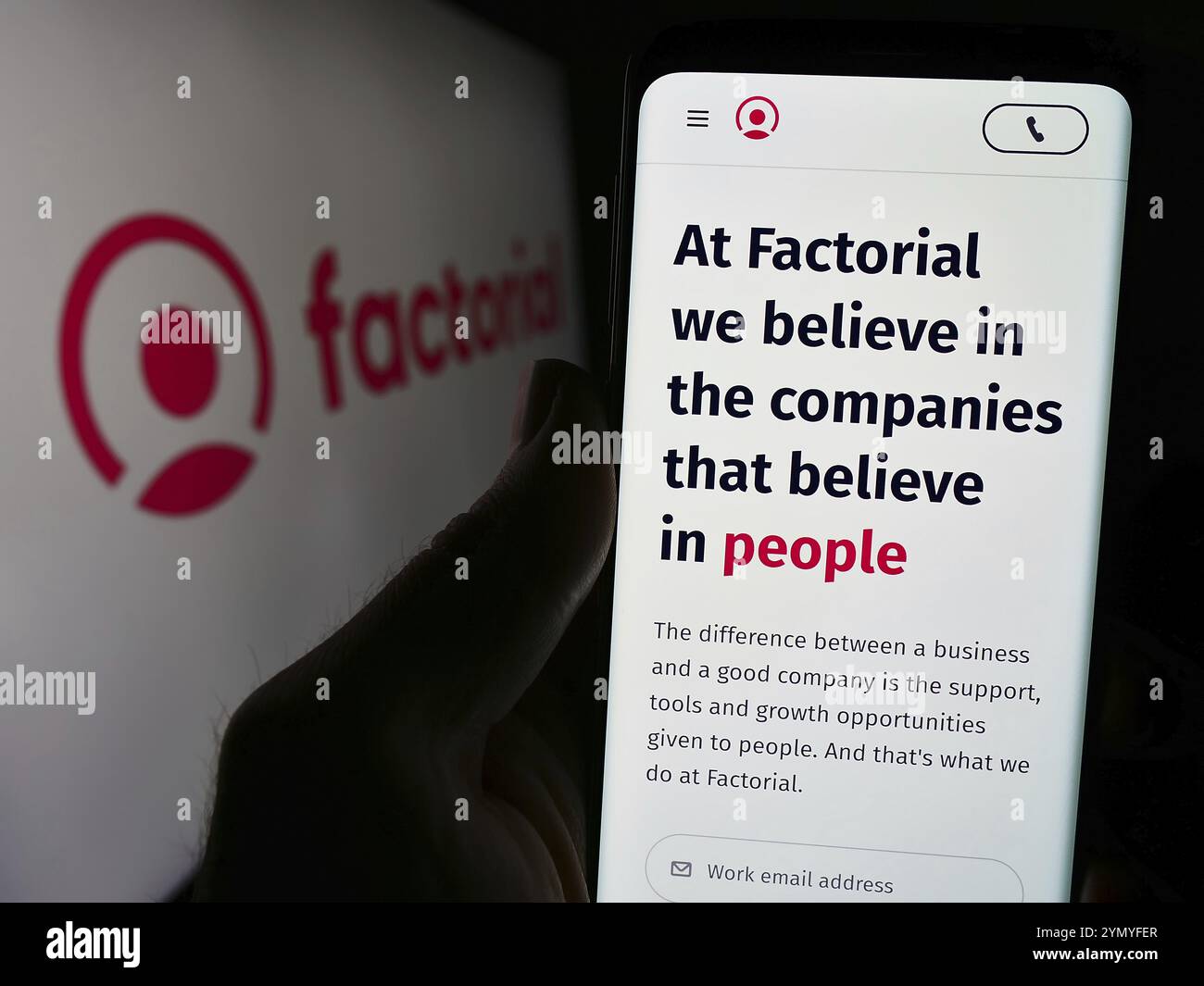 Stoccarda, Germania, 03-28-2024: Persona che detiene il cellulare con pagina web della società spagnola Everyday software S.L. (fattoriale HR) davanti al logo. Concentrati Foto Stock