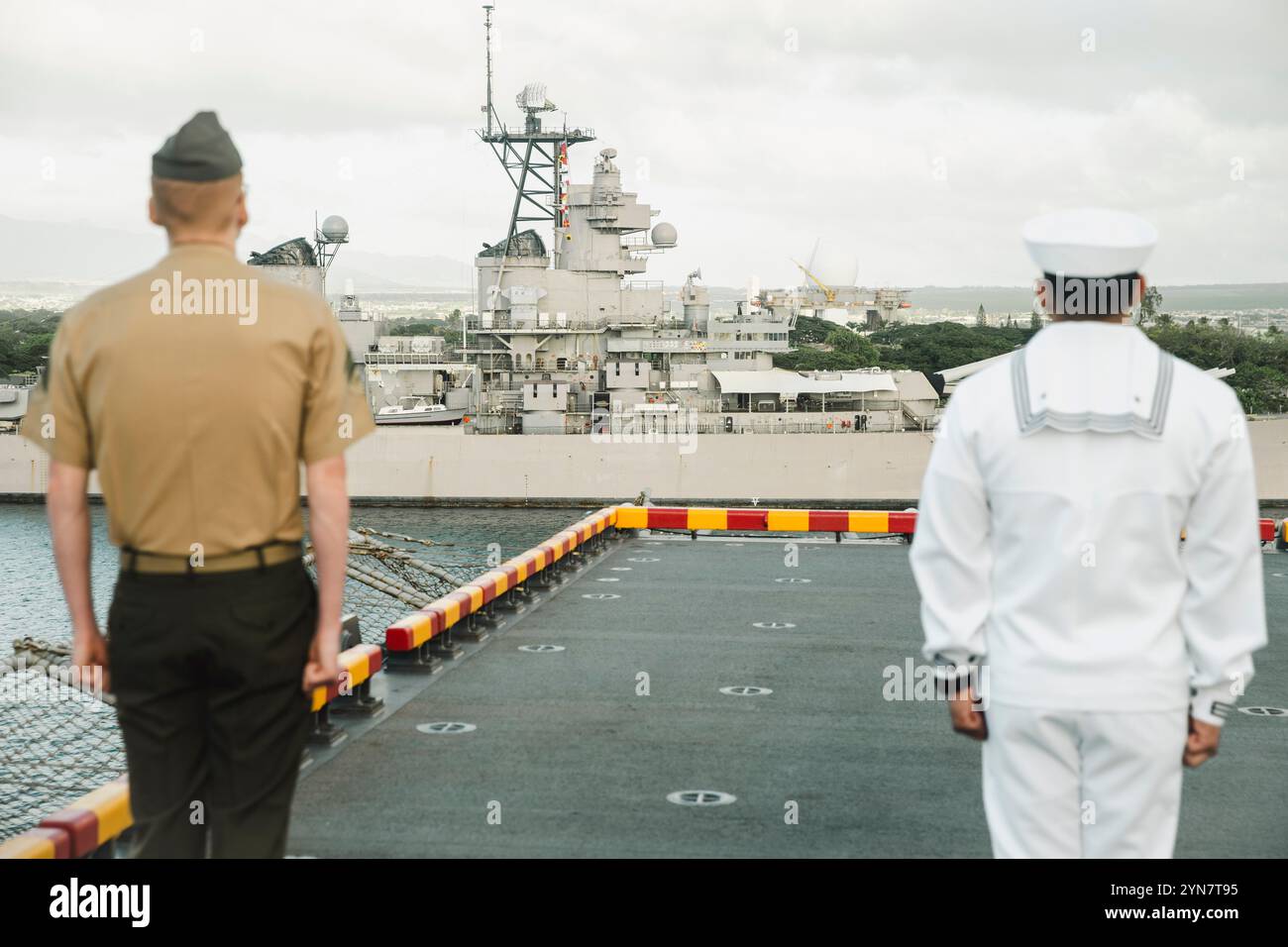 Charles Kelly, a sinistra, un meccanico del generatore assegnato alla 15th Marine Expeditionary Unit e nativo del Missouri, e un marinaio assegnato alla nave d'assalto anfibia USS Boxer (LHD 4) sono all'attenzione mentre maneggiano i binari come Boxer mentre la nave passa oltre la corazzata Missouri partendo dalla Joint base Pearl Harbor-Hickam, Hawaii, 15 novembre 2024. Elementi della 15a MEU sono attualmente imbarcati a bordo della Boxer e stanno conducendo operazioni di routine nella 3a flotta degli Stati Uniti. (Foto del corpo dei Marines degli Stati Uniti del Cpl. Luis Agostini) Foto Stock