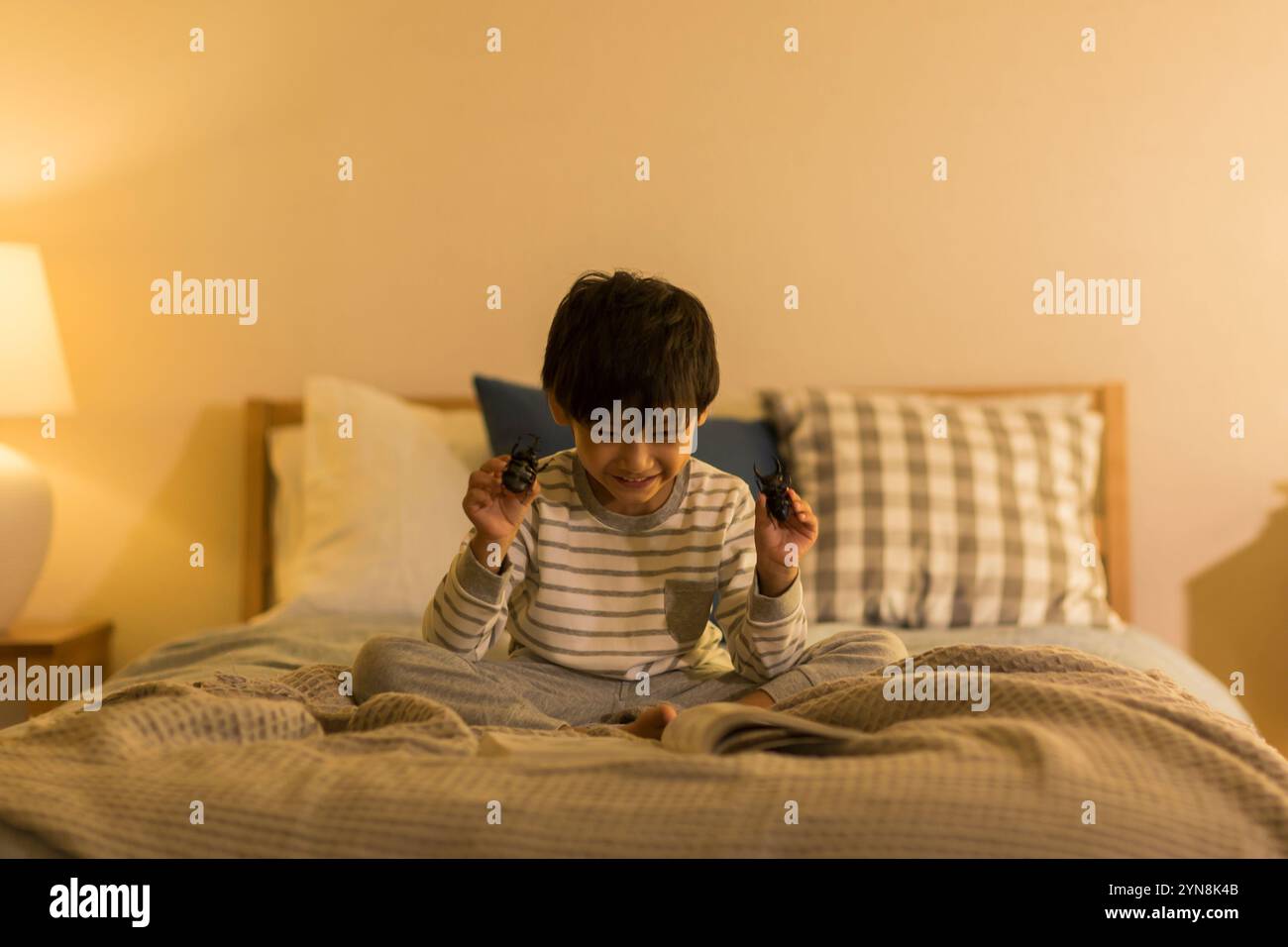 Bambino che tiene in mano un giocattolo per insetti Foto Stock