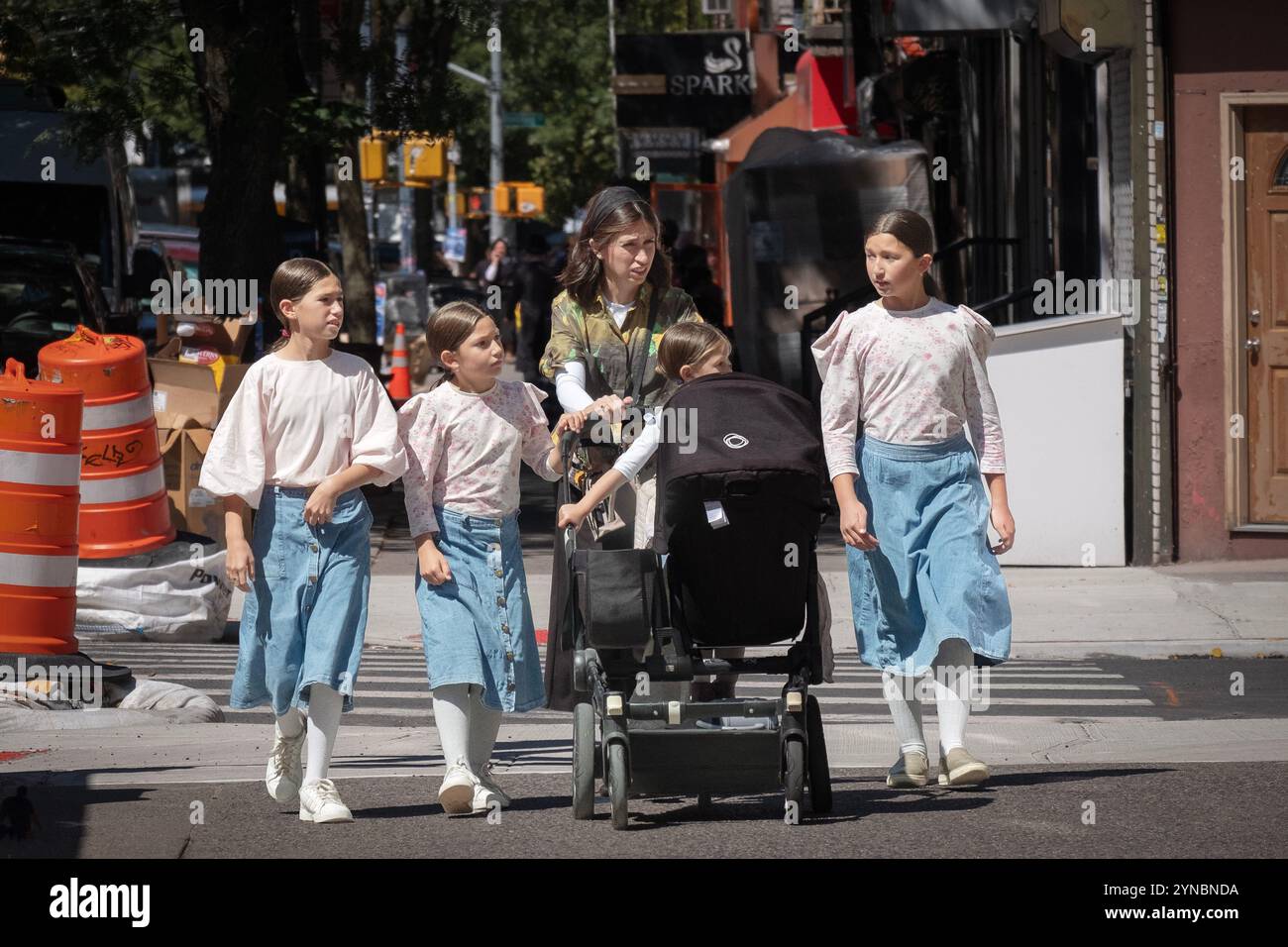 Una madre ebrea ortodossa e le sue figlie con un aspetto simile camminano su Lee Avenue a Brooklyn, New York. Foto Stock
