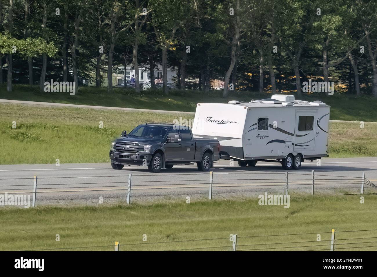 Calgary, Alberta, Canada. 1 agosto 2023. Un autocarro che traina un rimorchio camper per per camper in autostrada Foto Stock