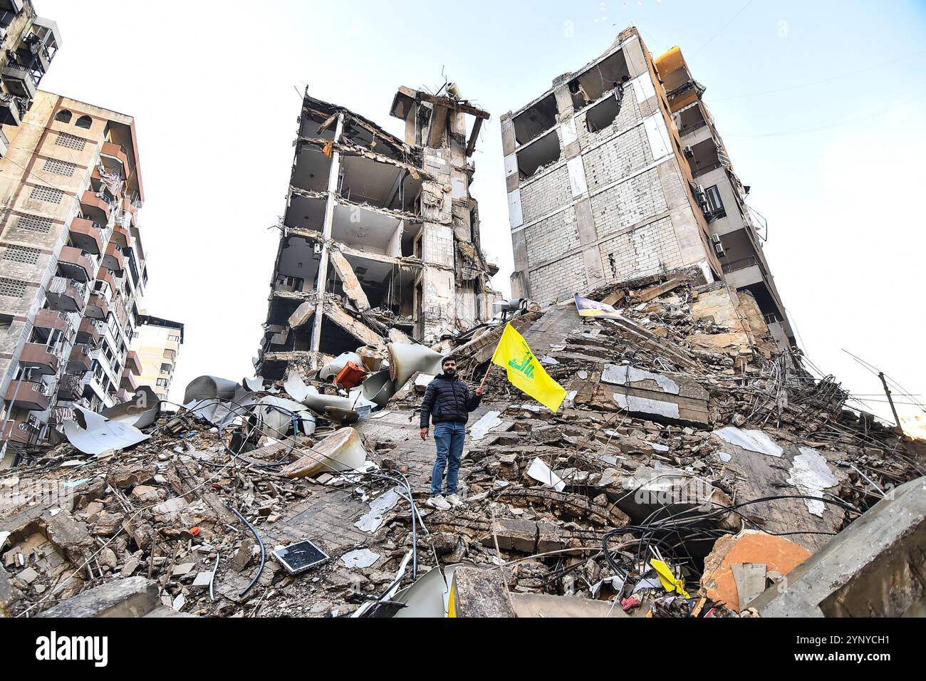 Beirut, Libano. 27 novembre 2024. L'uomo libanese Hezbollah ha la bandiera, restituisce le proprie case con veicoli dopo che l'accordo di cessate il fuoco tra Israele e Libano è entrato in vigore nella regione di Dahieh a Beirut, Libano, il 27 novembre 2024. Foto di FADEL ITANI/UPI. Crediti: UPI/Alamy Live News Foto Stock