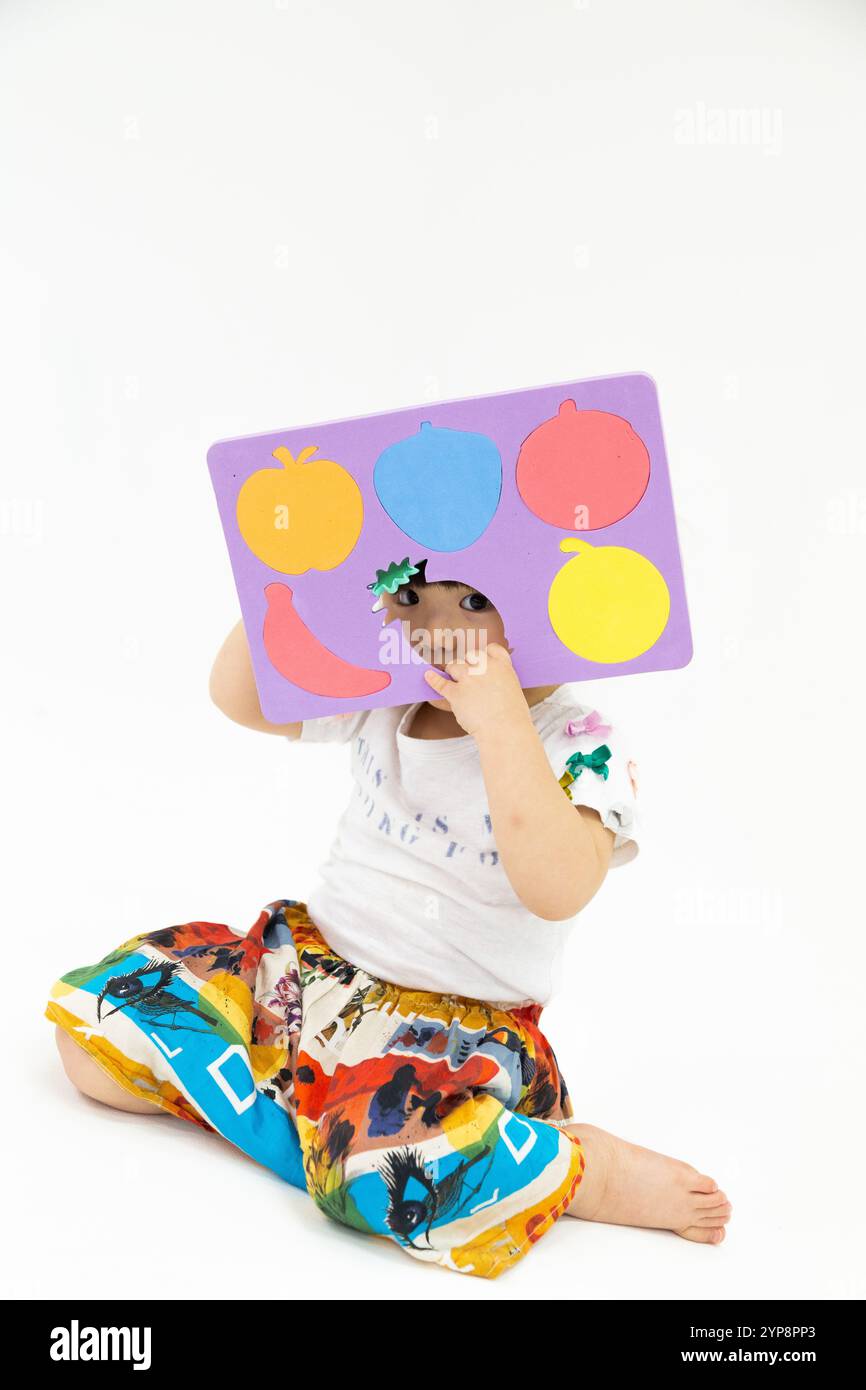 Una ragazza che gioca con un puzzle Foto Stock