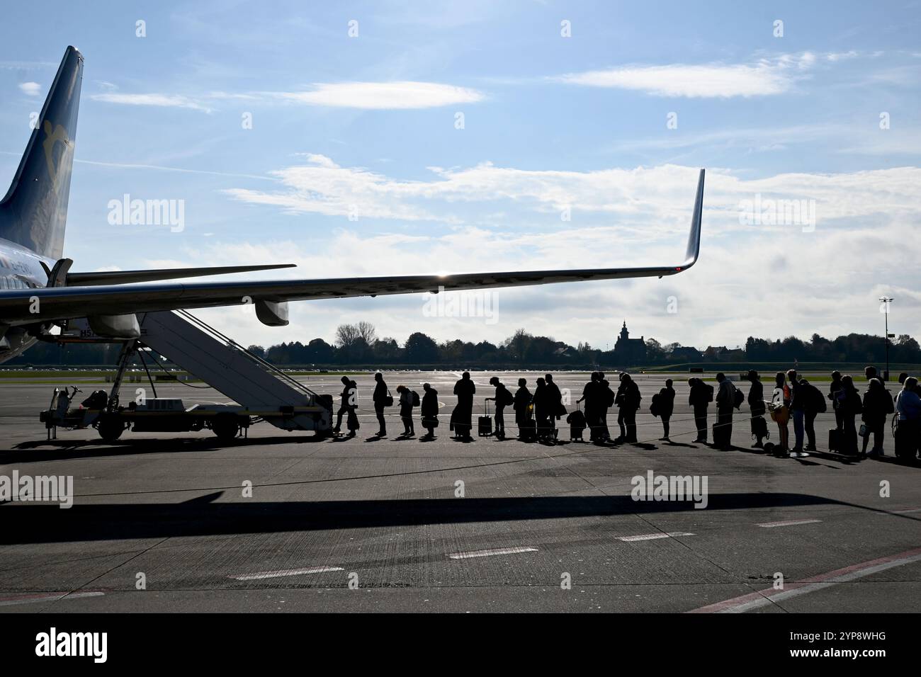 Persone in attesa di salire a bordo di un aereo in coda sulla pista - Charleroi, Belgio - 25 ottobre 2024 Foto Stock