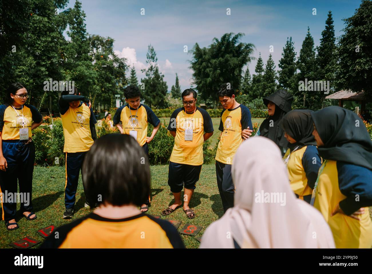 Bogor, 20 novembre 2024. Un gruppo di persone impegnato in attività di team building su un campo aperto, promuovendo il lavoro di squadra e la collaborazione. Ideale per Foto Stock