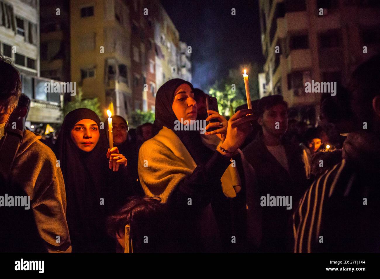 Beirut, Libano. 30 novembre 2024. Una donna tiene una candela in un memoriale per l'ex leader degli Hezbollah Hassan Nasrallah, a seguito di un cessate il fuoco tra Hezbollah e Israele. Hassan Nasrallah è stato ucciso il 27 settembre 2024, quando Israele ha sganciato bombe "bunker buster", livellando più blocchi di appartamenti nella periferia meridionale di Beirut. Credito: SOPA Images Limited/Alamy Live News Foto Stock