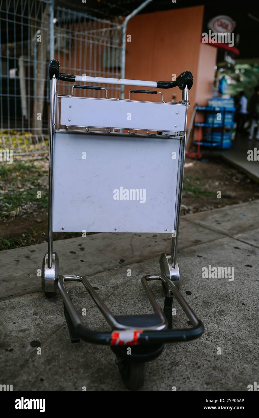 Carrello portabagagli con borse di grandi dimensioni in aeroporto, utilizzato per trasportare oggetti pesanti o multipli attraverso il terminal. Foto Stock