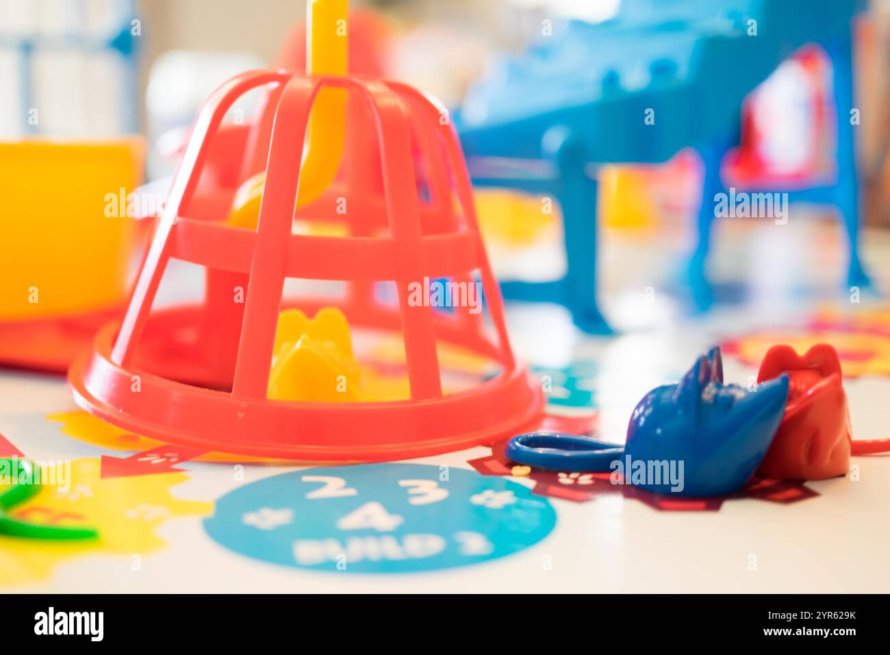 Colorato gioco educativo per bambini con forme e pezzi in plastica sul tavolo Foto Stock