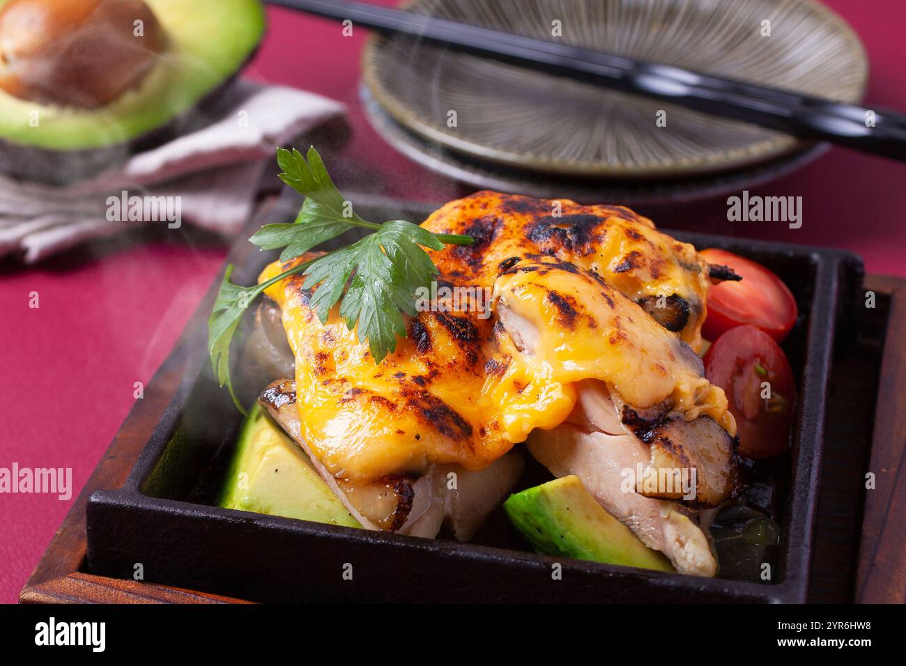 Avocado di pollo grigliato su teppan con formaggio Foto Stock