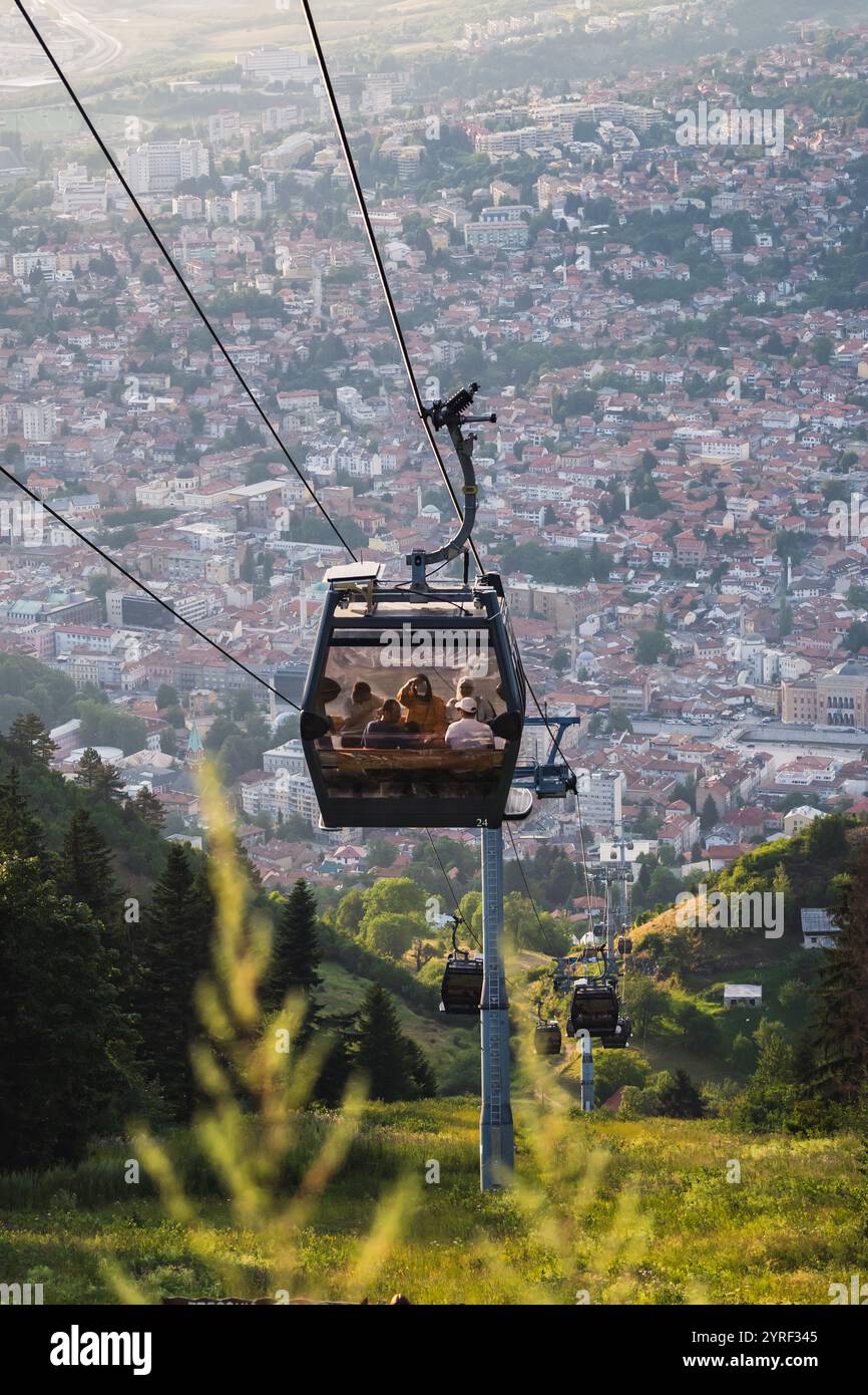 Una gondola a Sarajevo, Bosnia, che offre vedute panoramiche della città e delle montagne circostanti, mescolando fascino urbano con bellezza naturale. Foto Stock