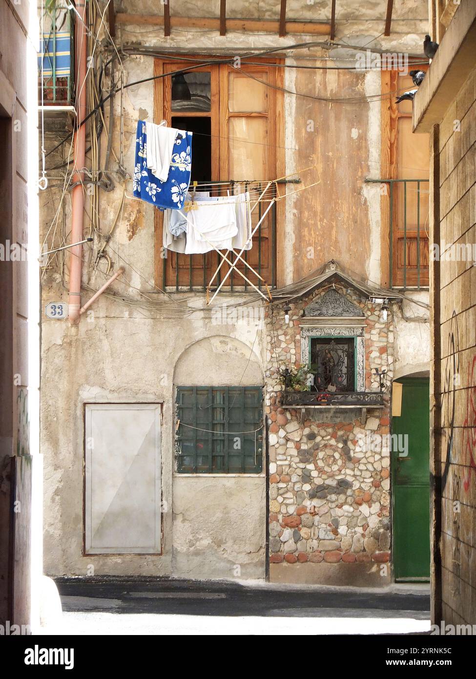 Appendiabiti davanti a una finestra in un vicolo di Palermo, Sicilia, Italia, Europa Foto Stock