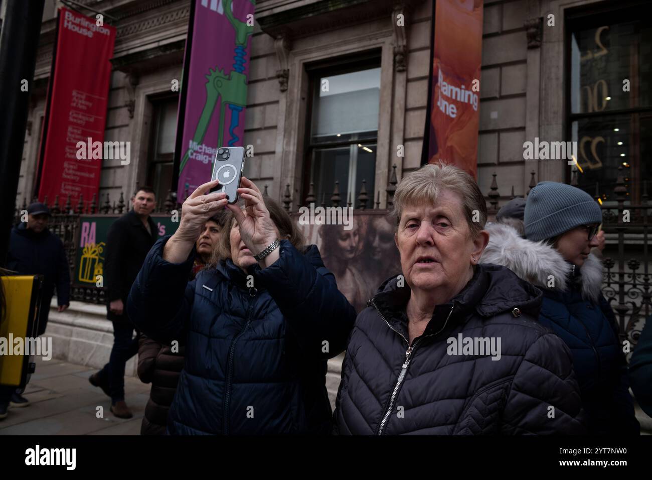 Gli amanti dello shopping natalizio si riuniscono sulla strada di fronte al Fortnum & Masons per scattare fotografie della facciata natalizia dei grandi magazzini di lusso, Piccadilly, Londra Foto Stock