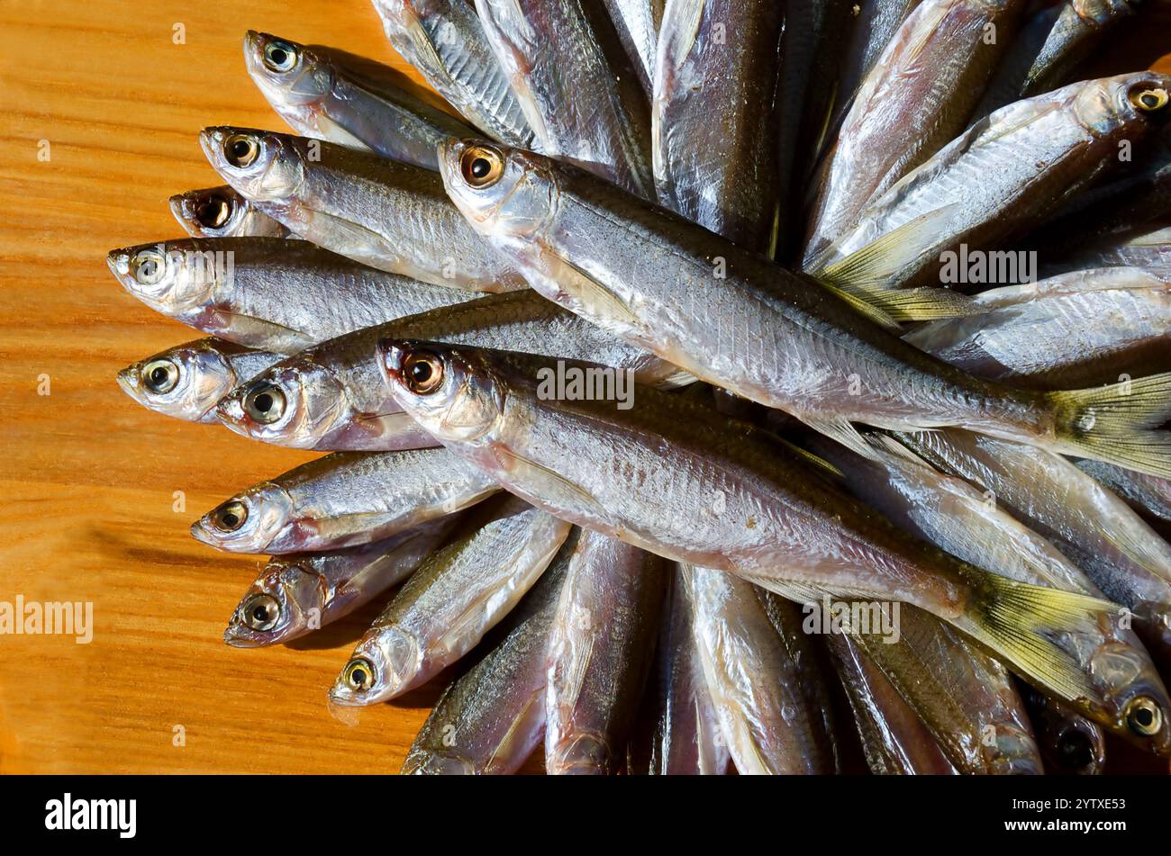 I pesci secchi sanguinano su una tavola di legno. Pesce grasso molto gustoso per la birra. Foto Stock