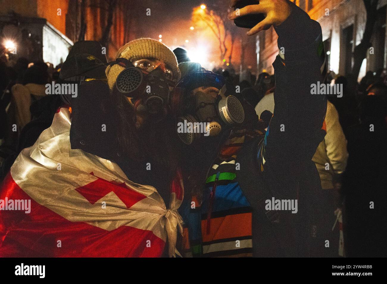 Tbilisi, Georgia - 1 dicembre 2024: Le giovani ragazze stanno con le bandiere UE e georgiane del parlamento. Il raduno su Rustaveli Avenue, lo slogan della ral Foto Stock