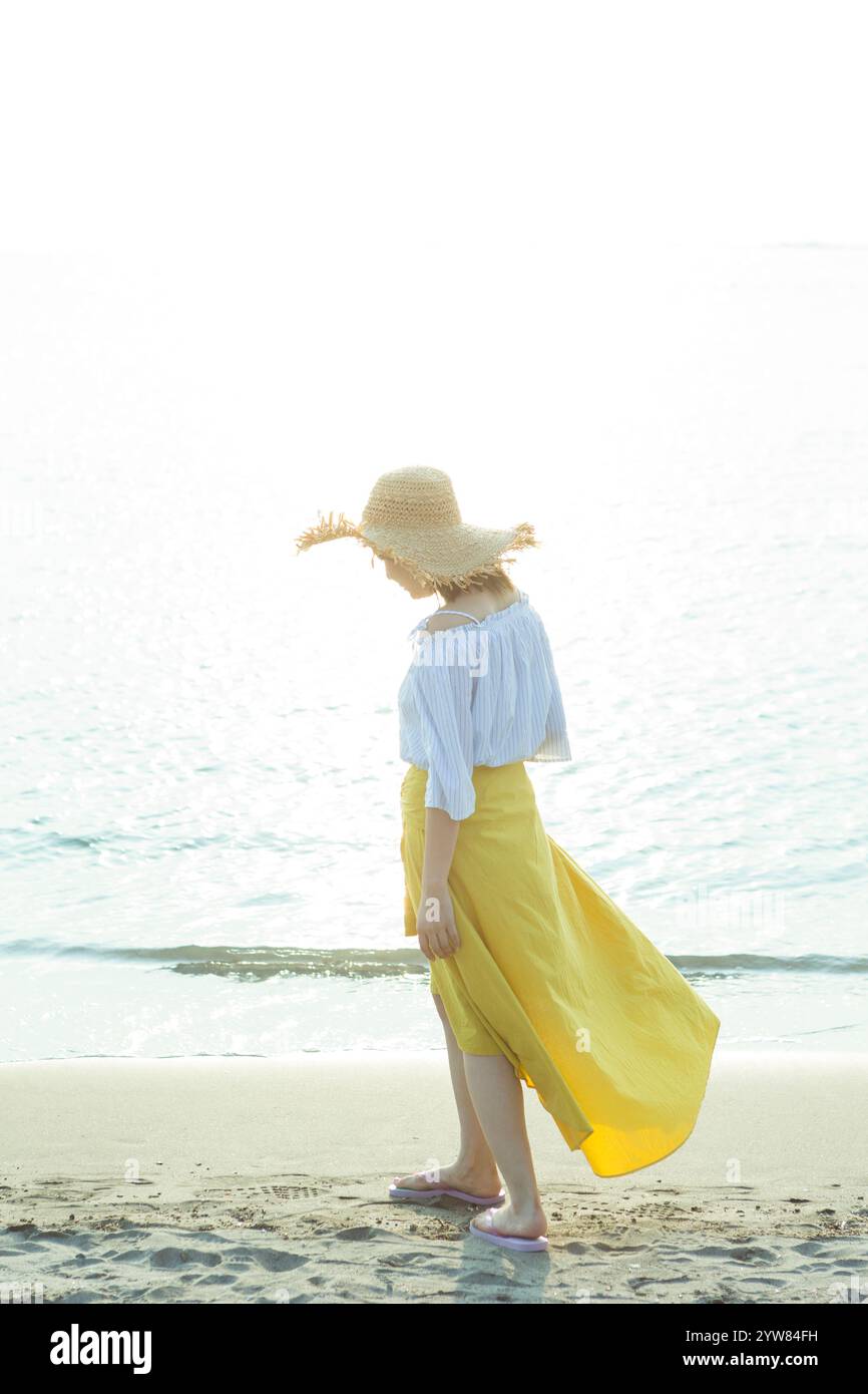 Donna di camminare sulla spiaggia Foto Stock