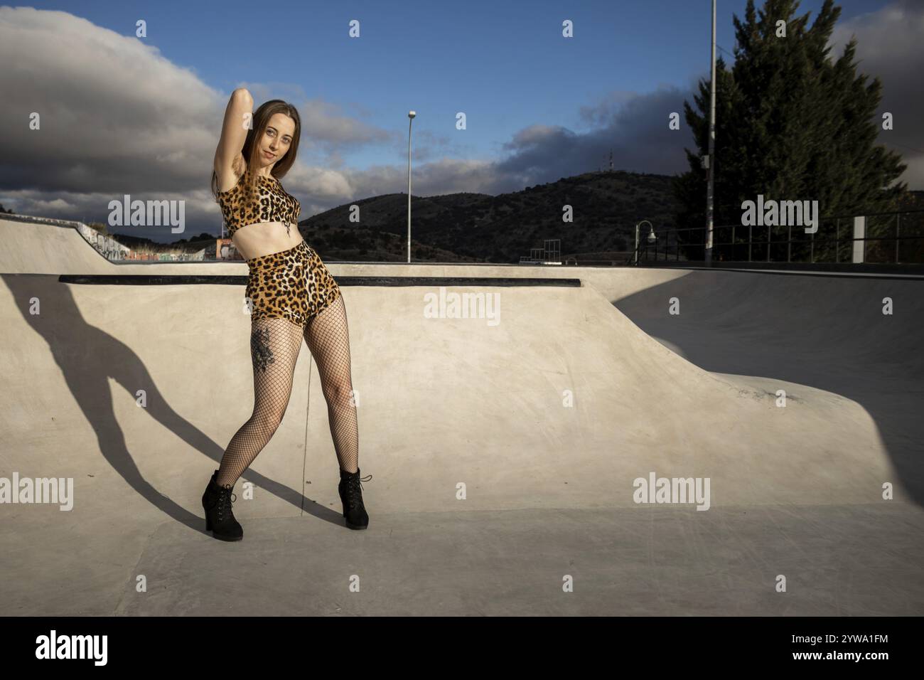 Donna con i capelli delle ascelle e l'abbigliamento corto con leopardo che danzano per strada Foto Stock