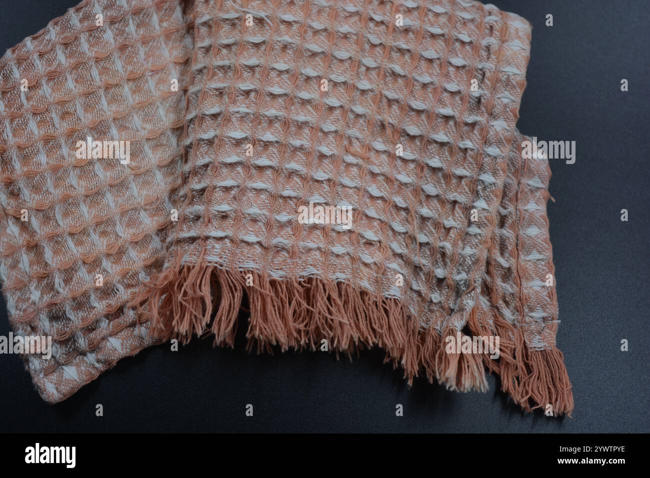 Tessuti morbidi, oggetti, tovaglioli in cotone sbiancato bianco e nero sono situati su uno sfondo in plastica nera. Foto Stock