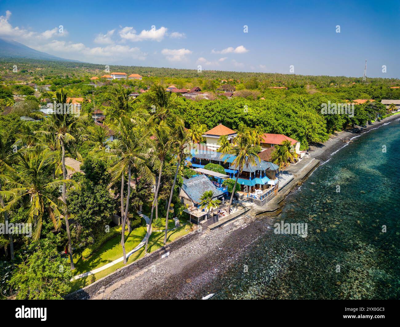 Vista aerea della costa tropicale di un'isola con vegetazione lussureggiante Foto Stock
