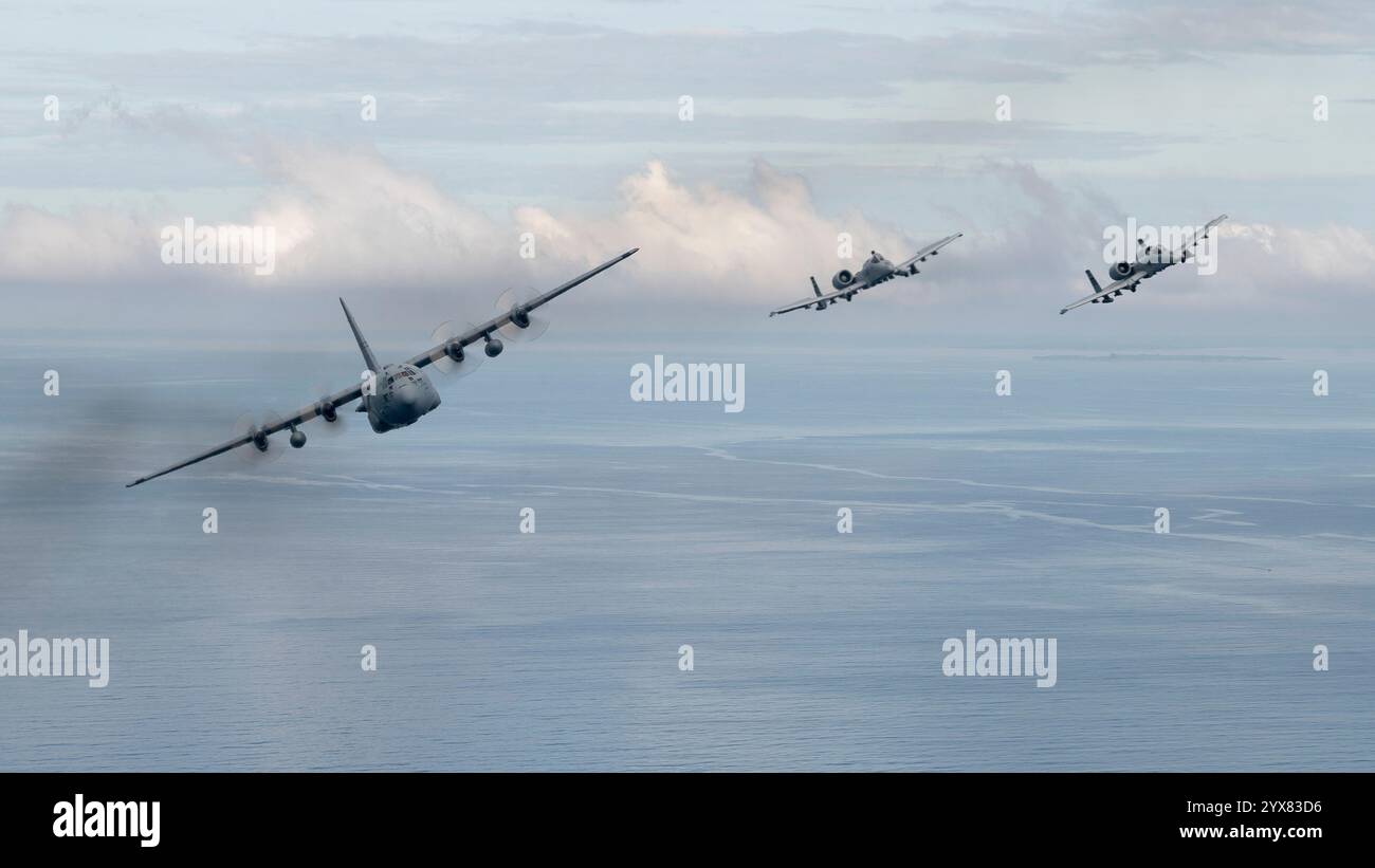 Un C-130 H2 Hercules della Missouri Air National Guard e due 25th Fighter Squadron A-10 Thunderbolt IIS volano in formazione sopra il Mar delle Filippine, 12 dicembre, Foto Stock