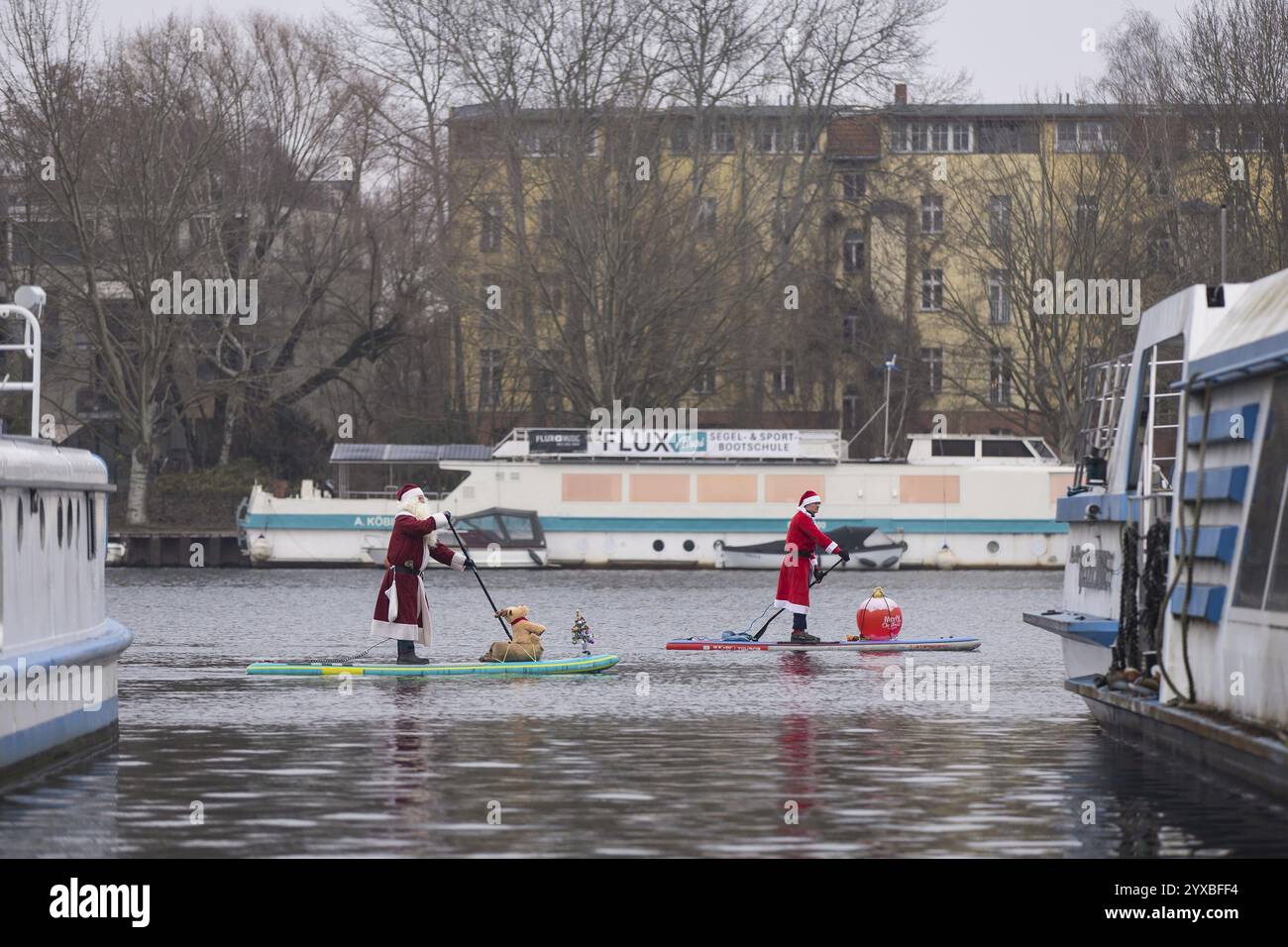 Gli appassionati di sport acquatici si sono vestiti da Santas su Sprea a Berlino il 14 dicembre 2024 Foto Stock