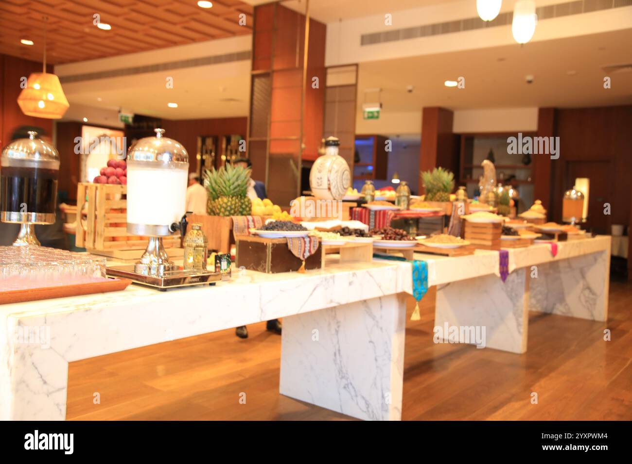 Vista ravvicinata del buffet allestito su squisiti tavoli in marmo, caratterizzato da una variegata selezione di delizie culinarie, completate da un arredamento di gusto. Foto Stock