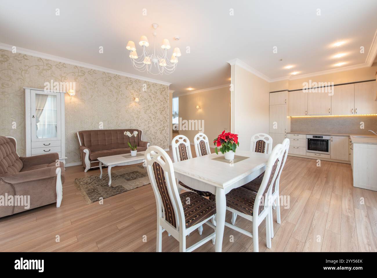 Un sofisticato spazio abitativo e da pranzo con arredamento di gusto, mobili di lusso e illuminazione calda. Ideale per una casa tranquilla ma elegante Foto Stock