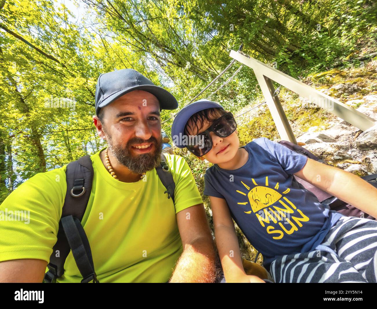 Padre e figlio si fanno un selfie mentre fanno un'escursione in una lussureggiante foresta verde, godendosi le loro vacanze estive nella splendida gola di tolmin, slovenia Foto Stock