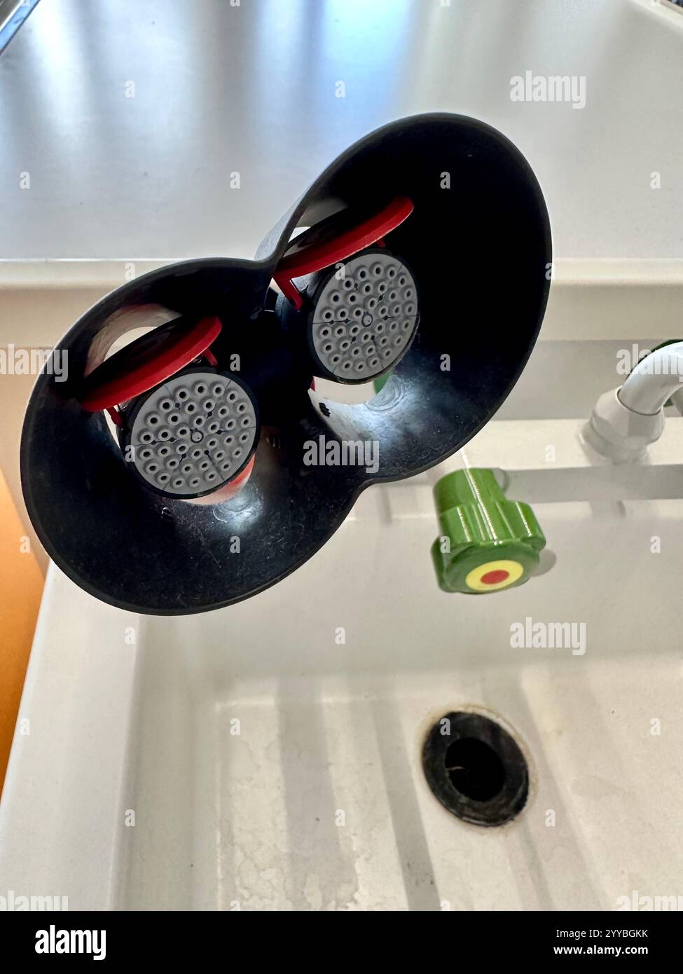 Stazione di lavaggio oculare di emergenza accanto a una stazione di lavoro in una sala di classe di scienze naturali Foto Stock