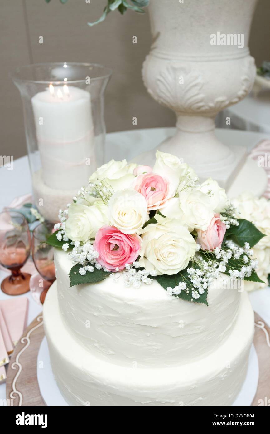 Torta nuziale in primo piano con fiori colorati Foto Stock