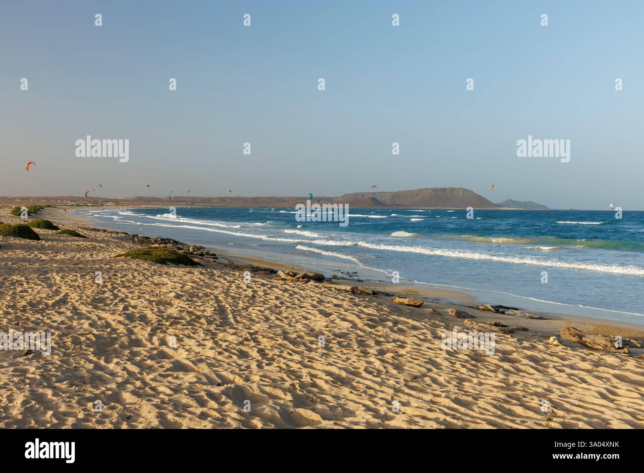 Un gruppo di kiteboarder viene trascinato attraverso l'acqua da un aquilone elettrico a Costa da Fragata, a sud-est dell'isola di Sal Foto Stock
