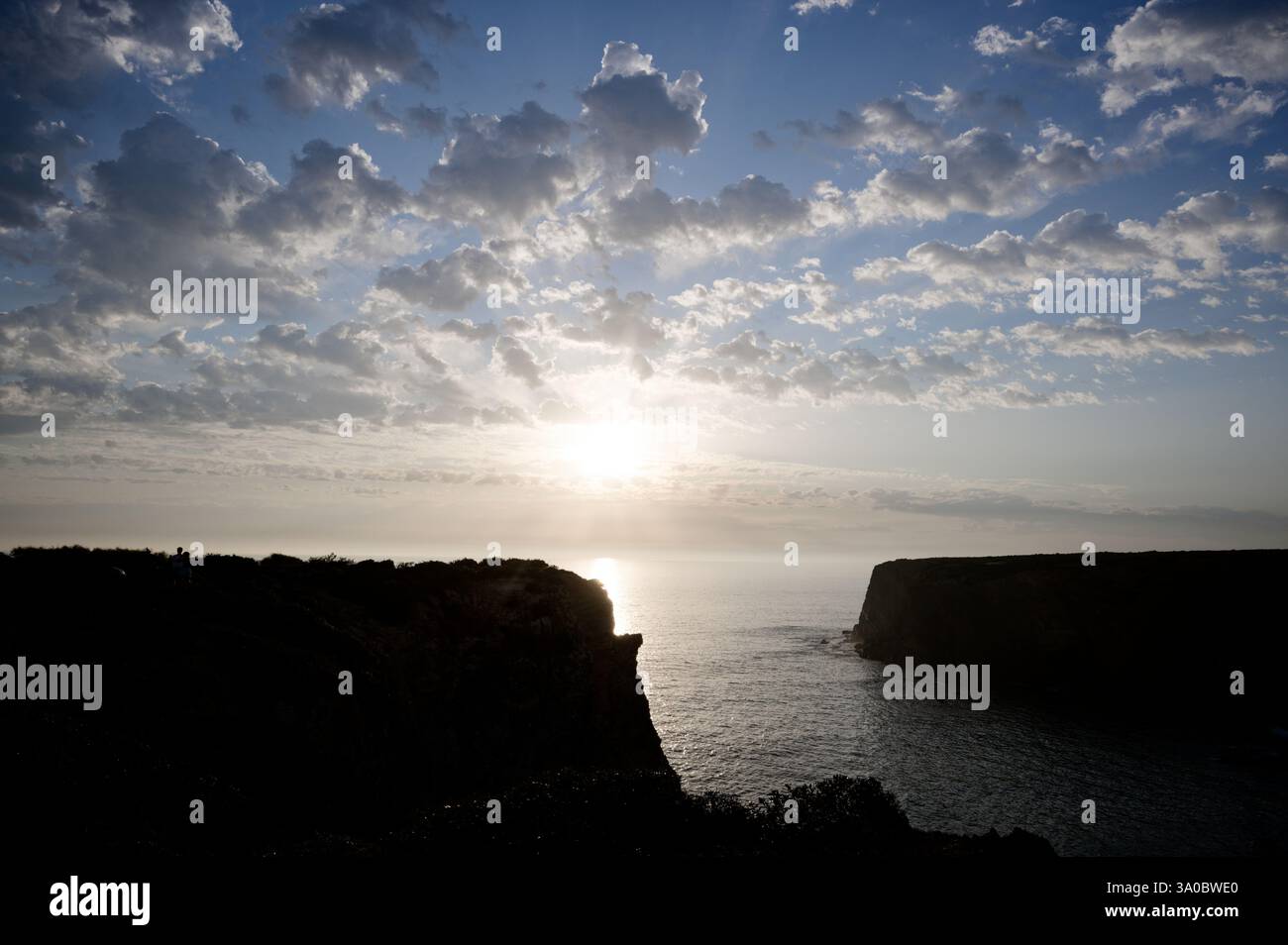 Tramonto dorato sulla spiaggia di Tonel a Baixo Alentejo, con scogliere che incorniciano l'orizzonte Atlantico Foto Stock