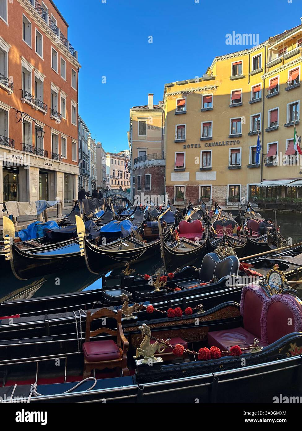 Vista panoramica del Canal grande di Venezia, con posti di ormeggio, un taxi d'acqua e colorati edifici storici al tramonto. - Immagine stock catturata con smartphone