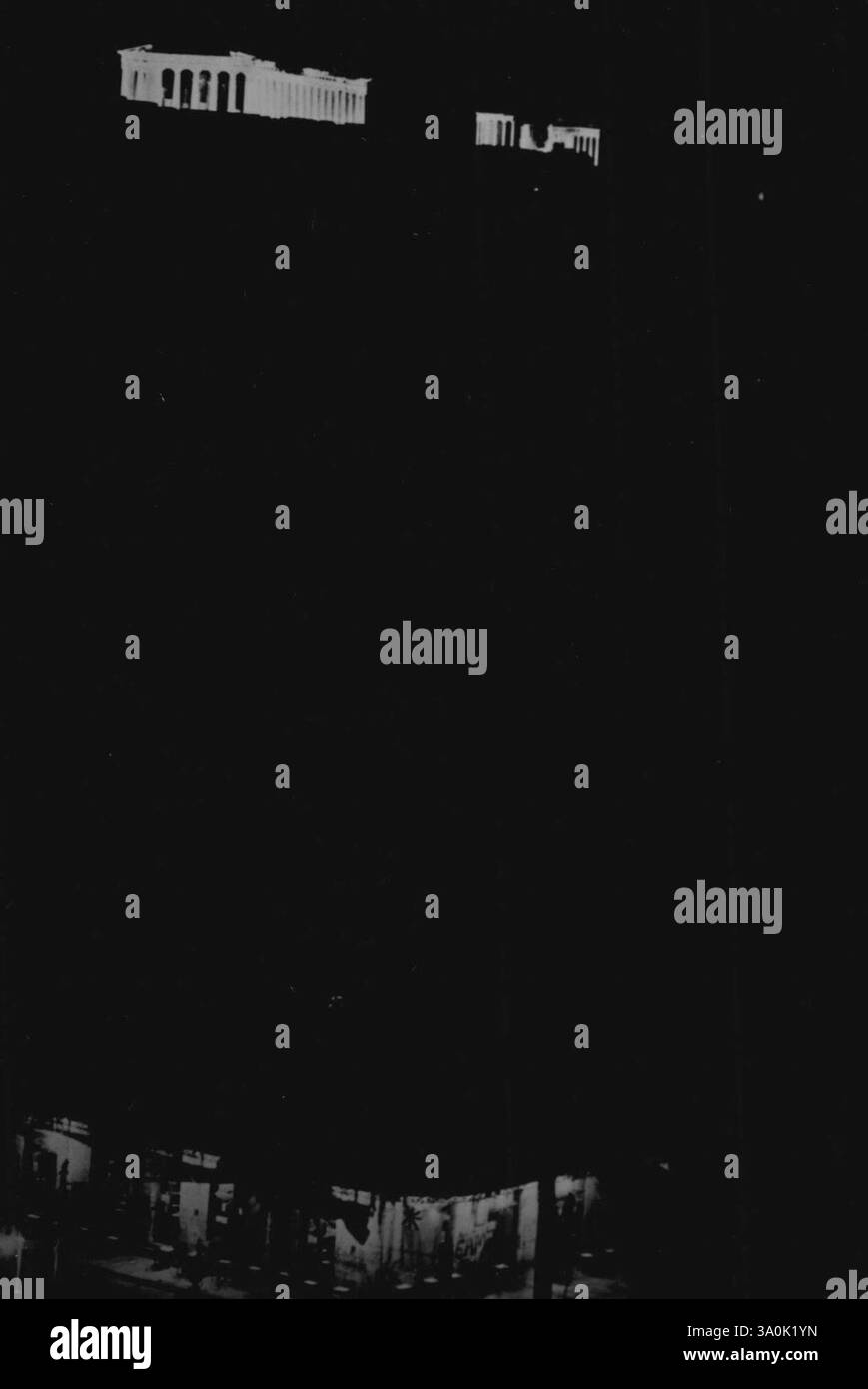 Le luci si accendono ad Atene liberata -- le colonne bianche e accese della storica Acropoli risalgono di notte, illuminate in alto su una collina sullo sfondo, mentre le luci stradali (in primo piano) di Atene continuano poco dopo la liberazione della capitale greca. Entro il 14 ottobre 1944. I combattenti patrioti e le truppe britanniche avevano cacciato i tedeschi dalla città, e il 4 novembre, il quartier generale alleato annunciò che tutta la Grecia era stata liberata dall'invasore. 11 dicembre 1944. (Foto dell'Office of War Information Picture statunitense). Foto Stock