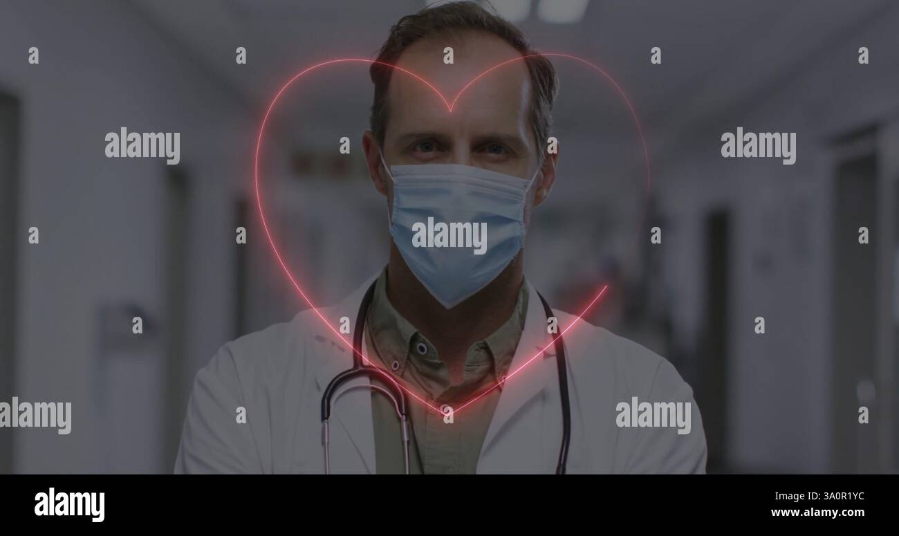 Immagine di cuore al neon sopra medico maschile caucasico con maschera facciale Foto Stock