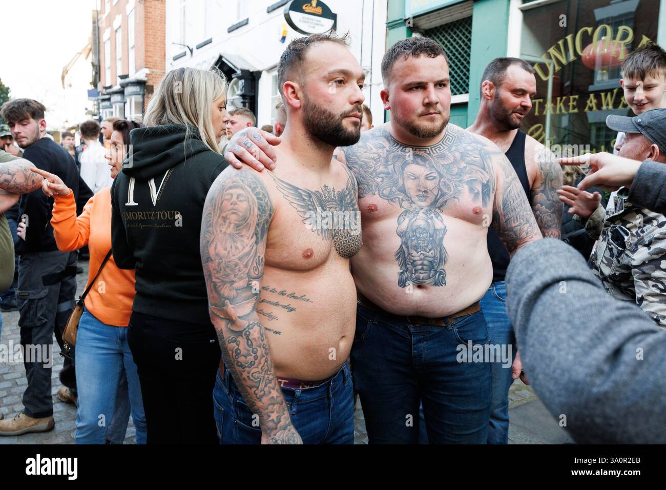 Atherstone Ball Game 2025. Nella foto, i concorrenti al di fuori del Club Liberale nella Piazza del mercato dopo la fine del gioco di palla. L'Atherstone Ball Game è una partita di "calcio medievale" giocata ogni anno lo Shrove Tuesday nella città inglese di Atherstone, Warwickshire. La partita onora una partita giocata tra Leicestershire e Warwickshire nel 1199, quando le squadre gareggiarono per una borsa d'oro, e che fu vinta dal Warwickshire. Un tempo eventi simili si tennero in molte città in tutta l'Inghilterra, ma quello di Atherstone è ora uno di almeno tre di questi giochi che vengono ancora giocati ogni anno a Shrovetide. Foto Stock