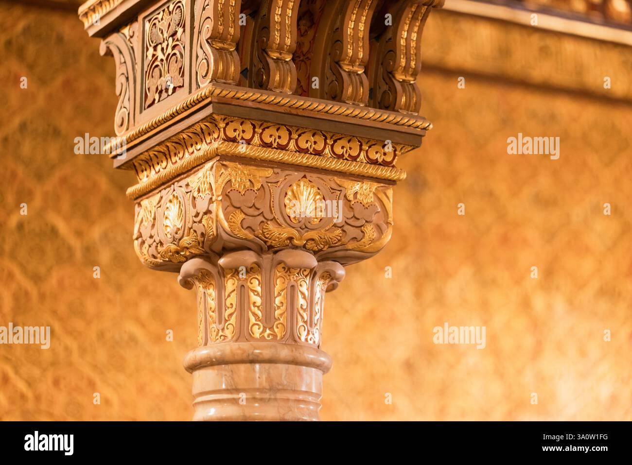 Una colonna decorativa splendidamente realizzata con dettagli dorati e design intricati, che fondono perfettamente arte tradizionale e artigianato architettonico Foto Stock