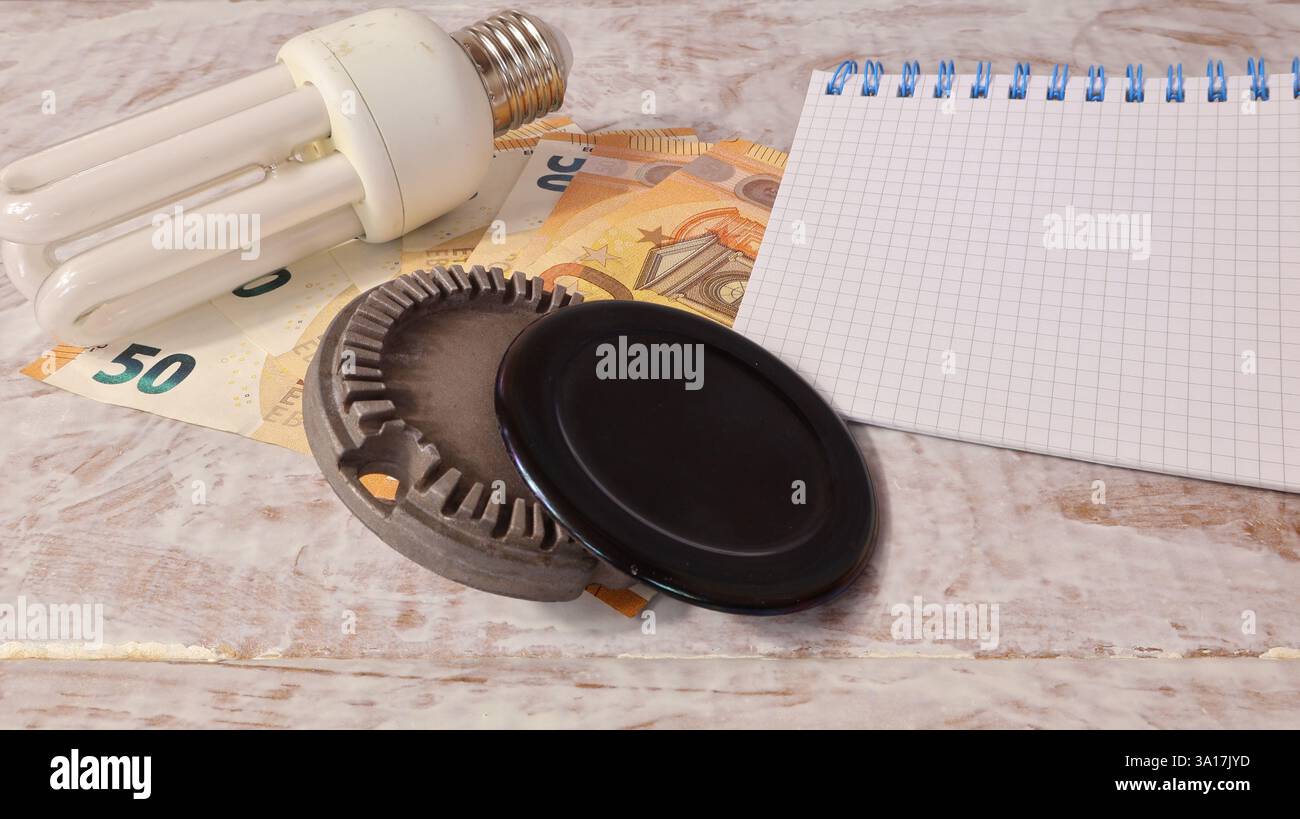 Consumi e spese per la distribuzione di gas ed elettricità di lampadine e gas con banconote in euro e sfondo neutro. Foto Stock