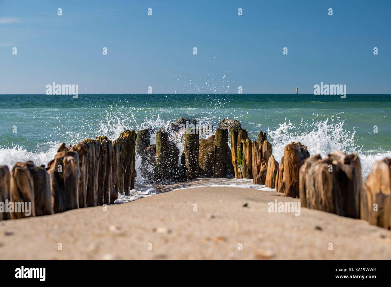 Fai surf con le onde in un vecchio groyne Foto Stock