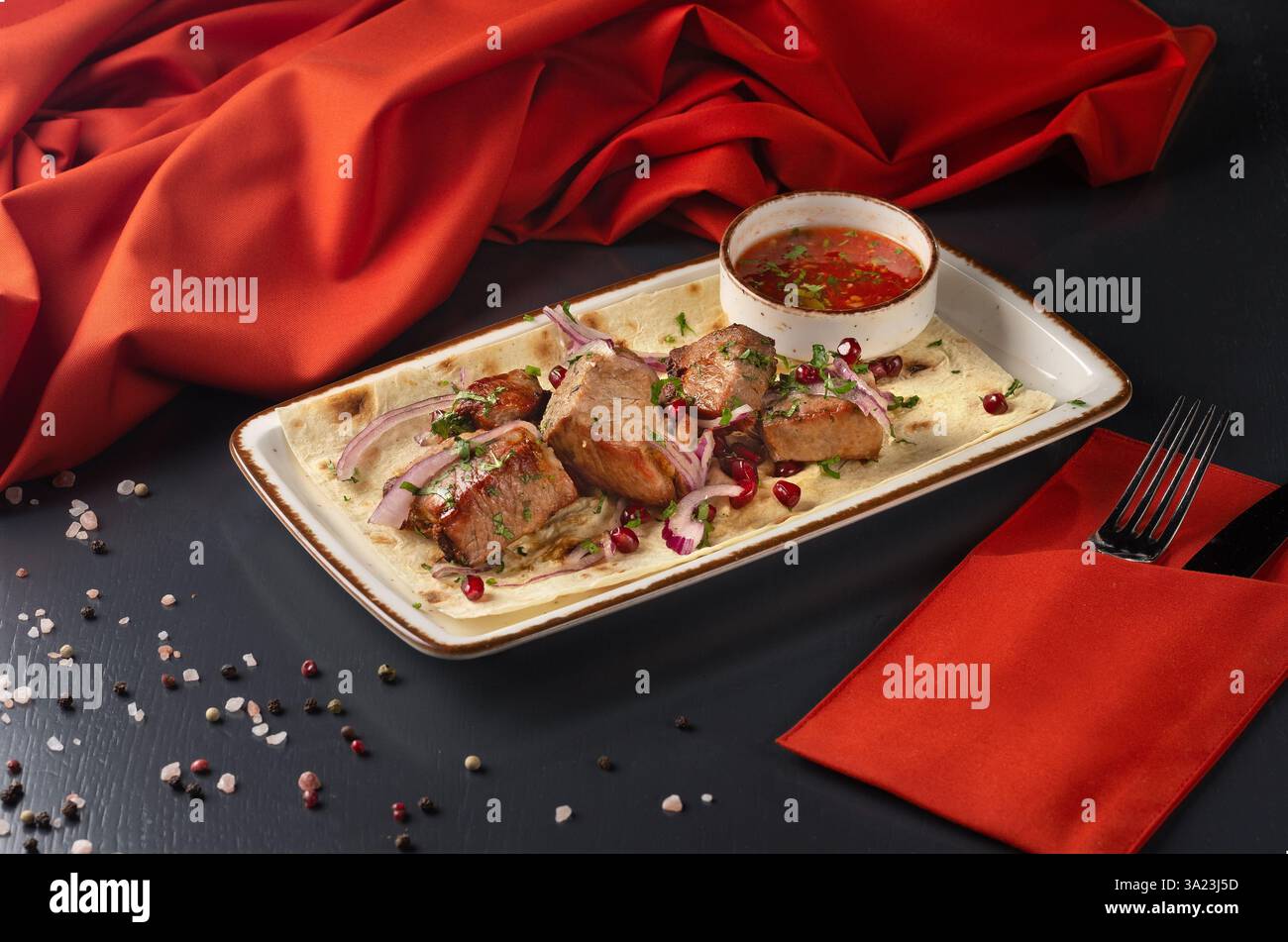 Shashlik georgiano con collo di maiale su spiedini su sfondo scuro. Menu per un ristorante georgiano. Menu del ristorante. Foto Stock