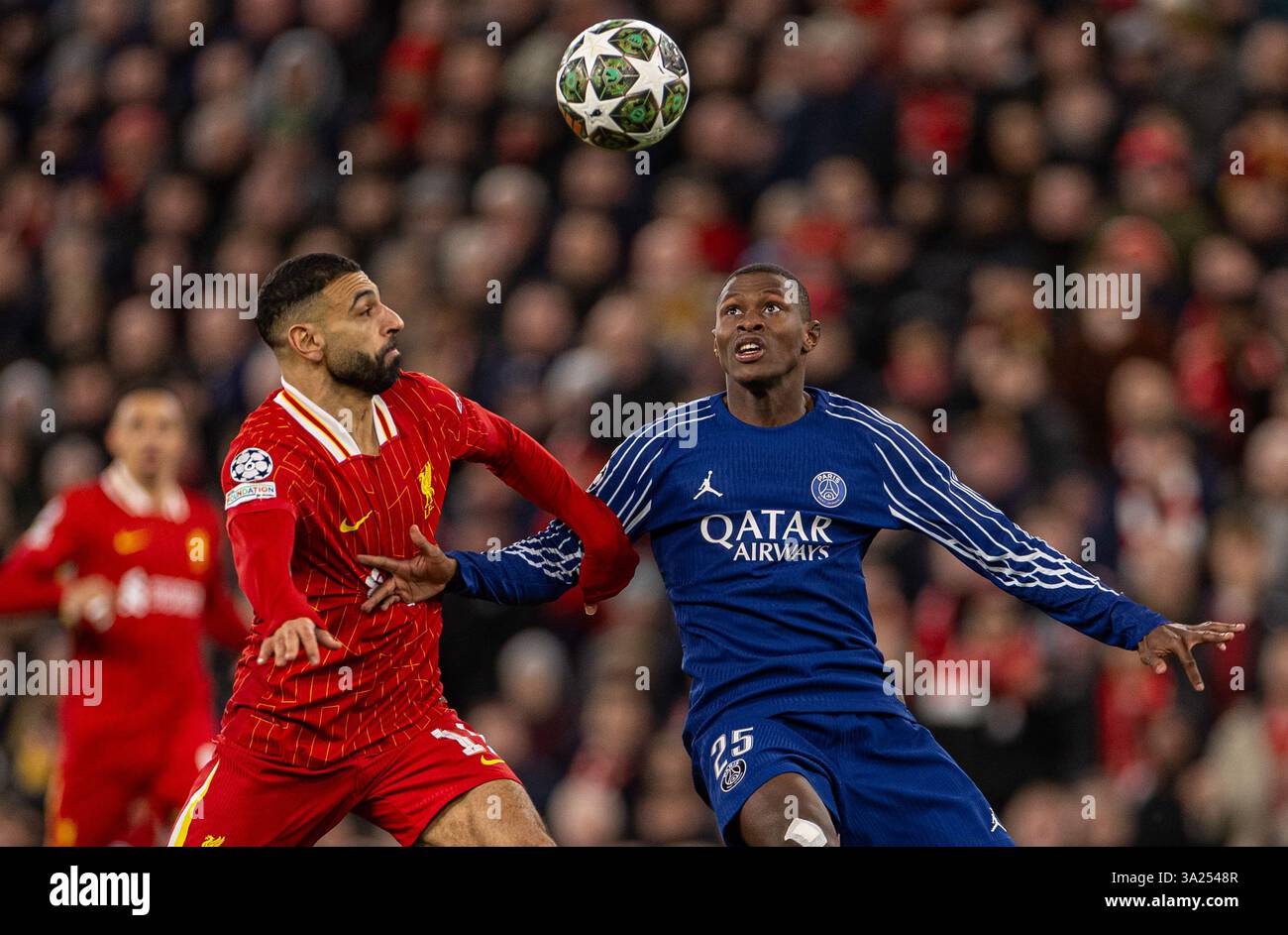 Liverpool. 12 marzo 2025. Mohamed Salah (L) del Liverpool è sfidato dal Paris Saint-Germain Nuno Mendes durante il turno di UEFA Champions League del 16 2nd Leg match tra Liverpool FC e Paris Saint-Germain FC a Liverpool, in Gran Bretagna, l'11 marzo 2025. Crediti: Xinhua/Alamy Live News Foto Stock