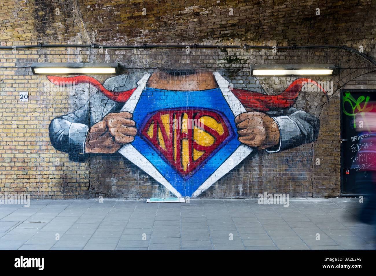 Graffiti NHS Superman sotto un arco ferroviario nel sud di Londra. Foto Stock