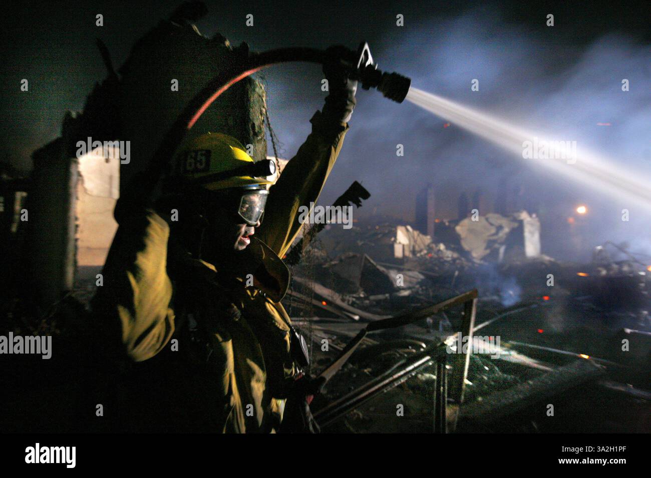 Il vigile del fuoco della contea di Los Angeles mette l'acqua per raffreddare una struttura su Malibu Canyon Drive vicino alla Pepperdine University, 21 ottobre 2007. Fire (credito: © Sacramento Bee/ZUMAPRESS.com) Foto Stock