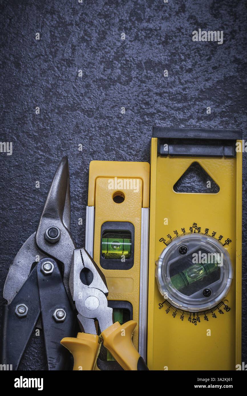 Set di pinze per acciaio livello di costruzione su sfondo nero Foto Stock