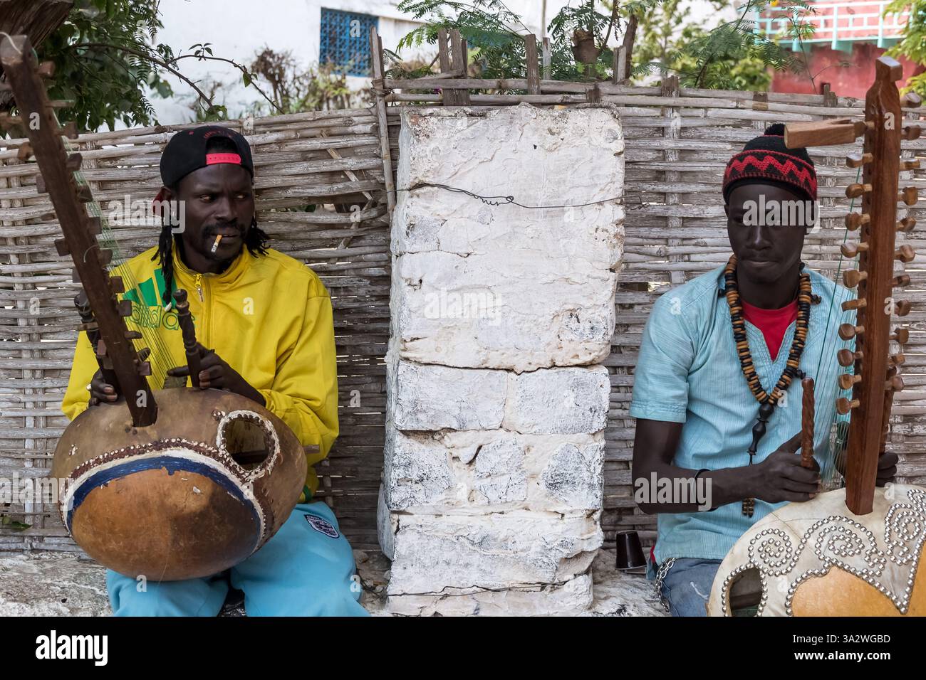Gorée Island, Senegal - due musicisti suonano la kora, uno strumento dell'Africa occidentale, sulle sue strade. Un sito UNESCO, è un memoriale alla tratta degli schiavi. Foto Stock